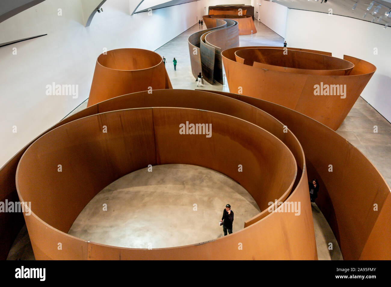 Richard Serra's 100m long steel 'Snake' installation. "The Matter of Time", Guggenheim Bilbao Museum, Nervión River, Bilbao, Basque Country, Spain Stock Photo
