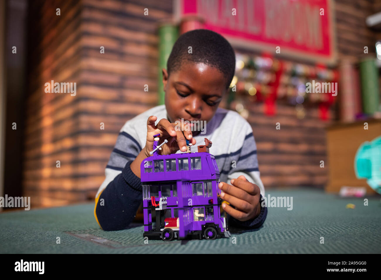 Peter Olunloyo, 8, plays with a Harry Potter Knight bus toy by LEGO, which  was named in the top 12 to buy during the unveiling of the annual DreamToys  list at St