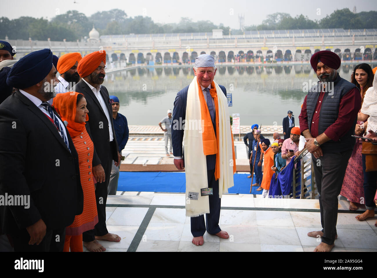 The Prince of Wales barefooted during his visit to the Bangla Sahib Gurdwara Sikh Temple, New Delhi, to celebrate the 550th anniversary of the birth of Guru Nanak, the founder of Sikhism, on day one of the royal visit to India. Stock Photo