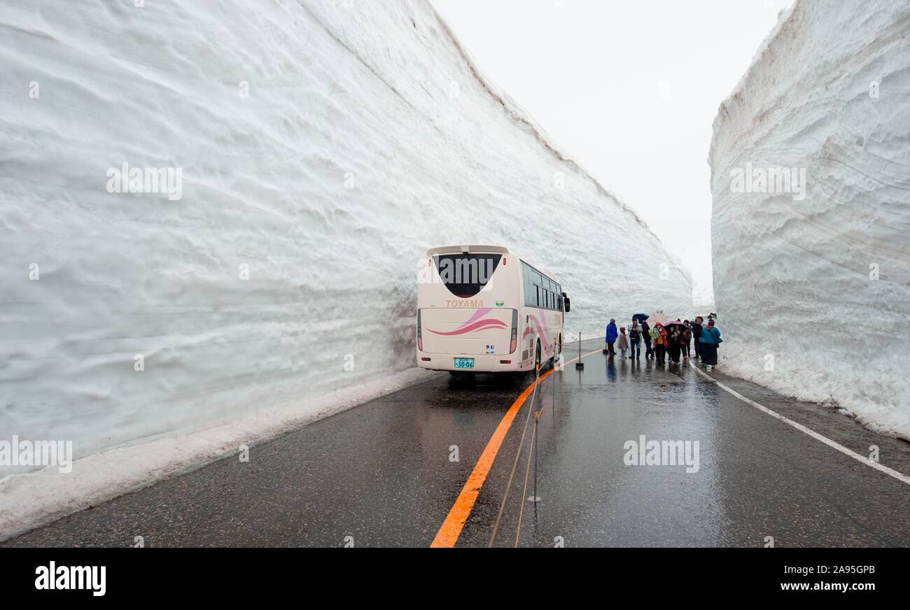 Snow Wall Walk, high snow wall on a road with bus, Tateyama Kurobe Alpine Route, Tateyama, Japan Stock Photo