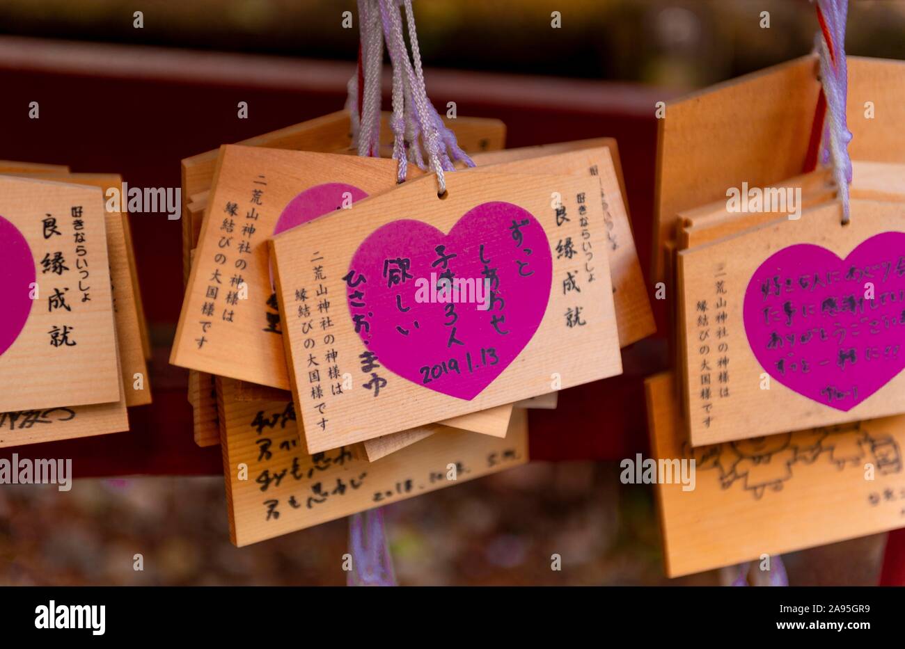 Heart with love message, written wishes to deities on small wooden