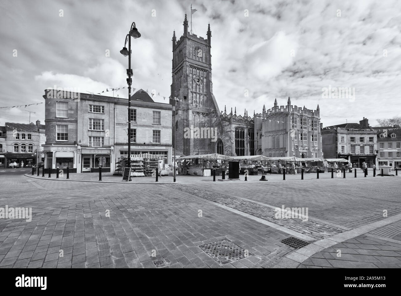 St John the Baptist parish church and the market place in the centre of Cirencester in Gloucestershire, UK Stock Photo