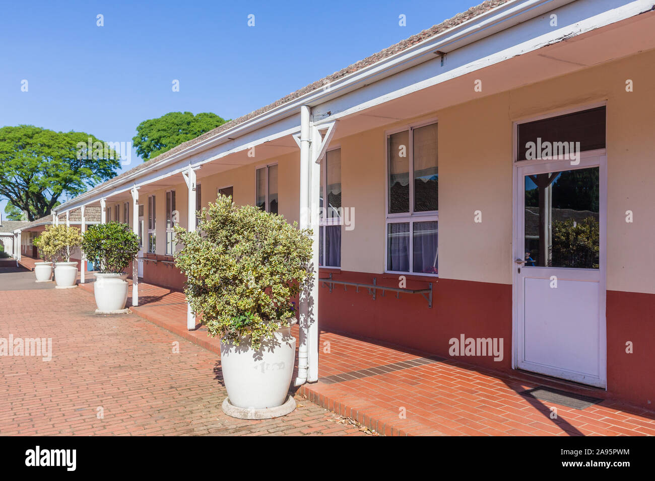 Ground level building with education classrooms offices with porch design structures closeup outdoors exterior in countryside landscape. Stock Photo
