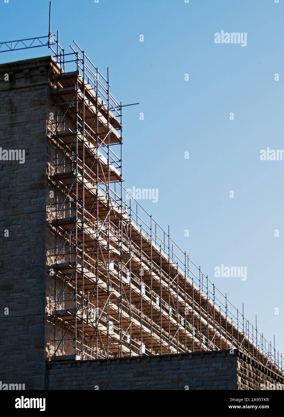 Scaffolding on a high section of a mill wall at Brierfield, Lancashire Stock Photo