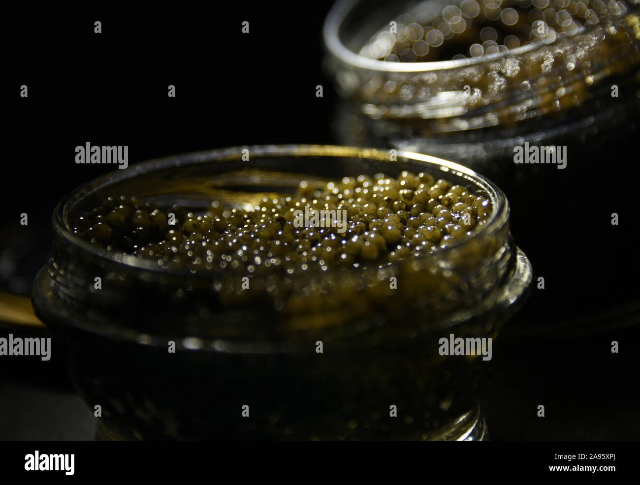 Black caviar in glass cans. Stock Photo