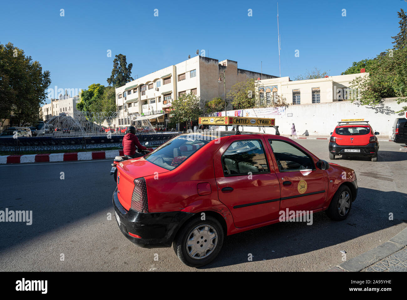 Fez, Morocco. November 9, 2019. A red petit taxi in a square Stock Photo