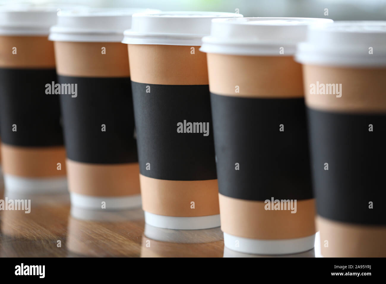 Paper cup line standing at table ready to be taken away Stock Photo - Alamy