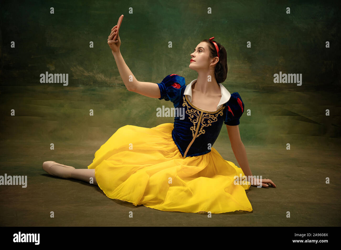 Young ballet dancer as a Snow White with tablet making selfie or