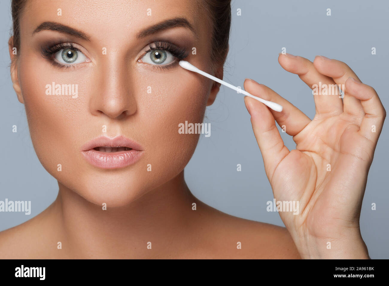 Beautiful woman with a cotton swab beside a her eye Stock Photo Alamy