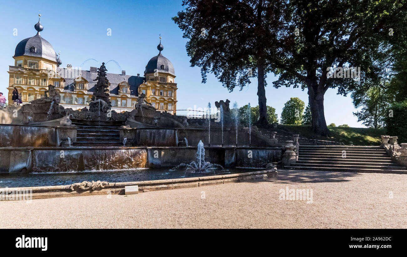 Bamberg 2019. Fountain with jets and Seehof castle. We are on a warm and sunny summer day and many people find refreshment in the Italian gardens of t Stock Photo