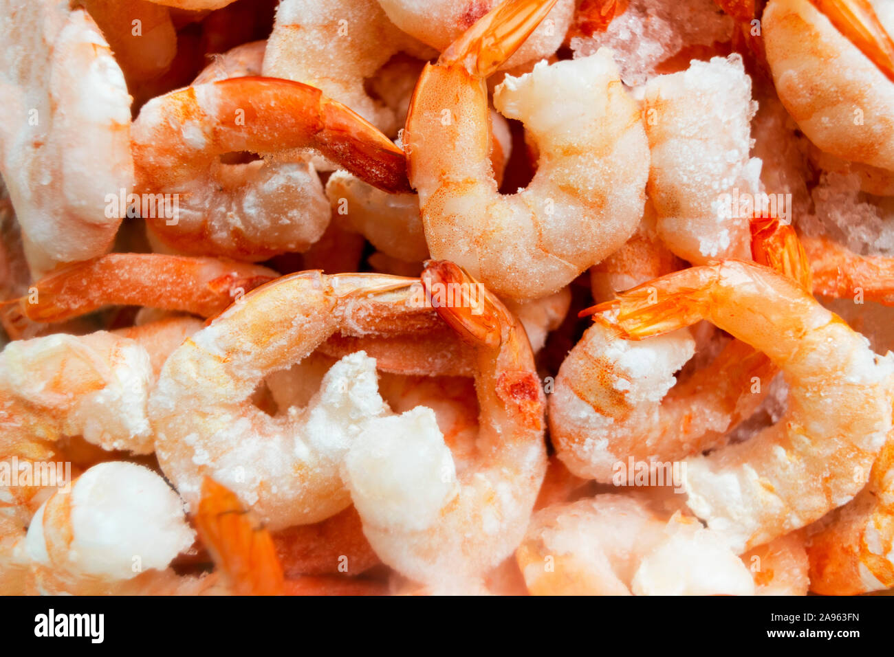 Raw frozen and peeled shrimp background. Pile of frozen shrimps .Close