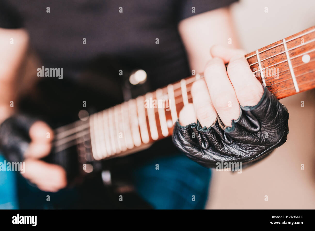 Close up of rocker guitarist hands playing heavy riff on electric guitar Stock Photo