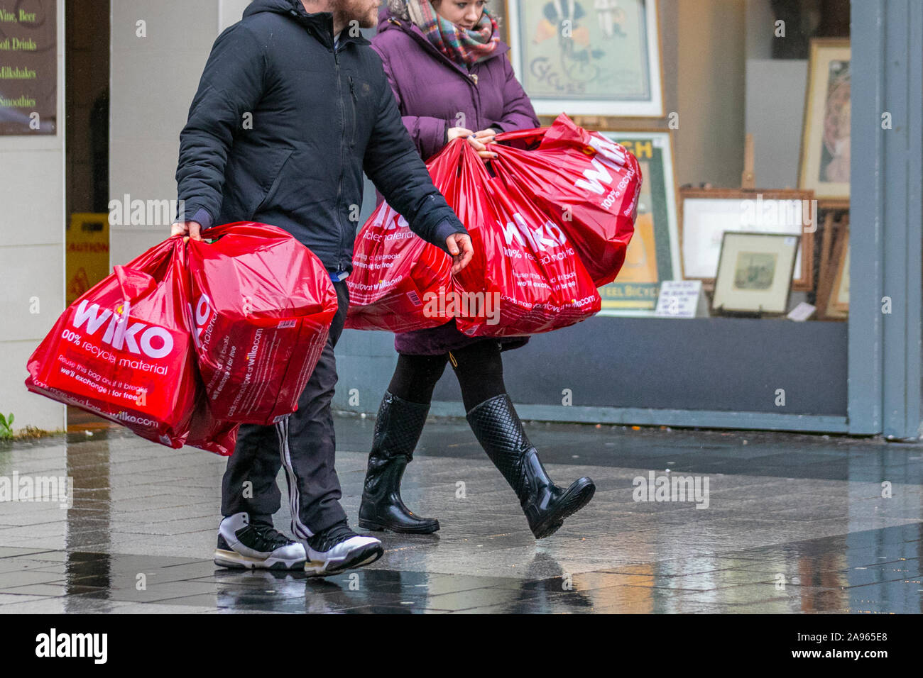 Two people carrying wilko store bags hires stock photography and