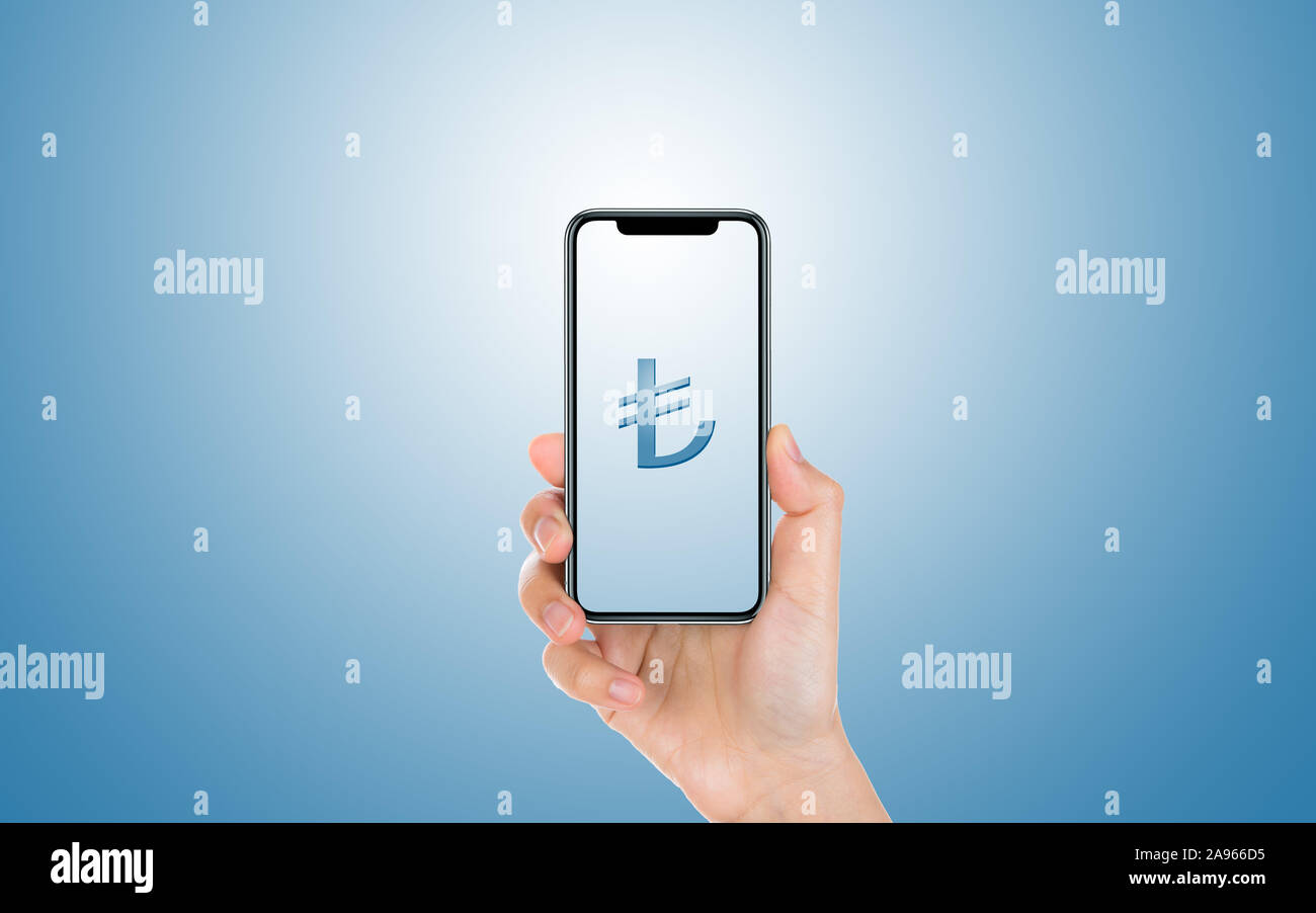 Male hand is holding and showing a modern smart phone screen Lira symbol against blue background. Business, finance, technology and mo Stock Photo - Alamy
