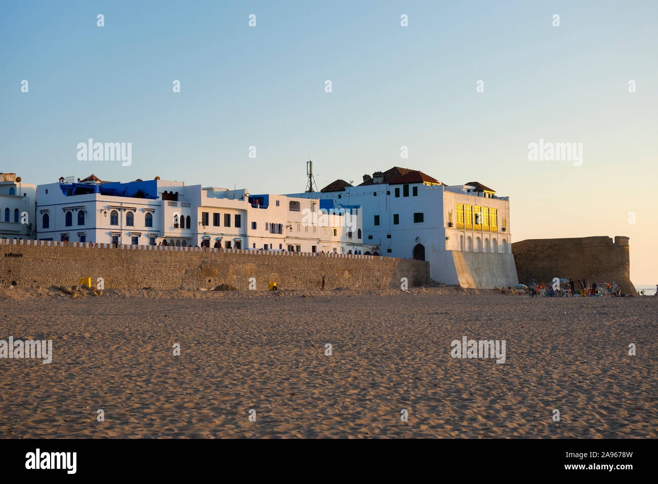 Asilah, Morocco-September 10, 2019: View from the beach to the old stone fortification wall of the medina from Asilah, Morocco late in the afternoon Stock Photo
