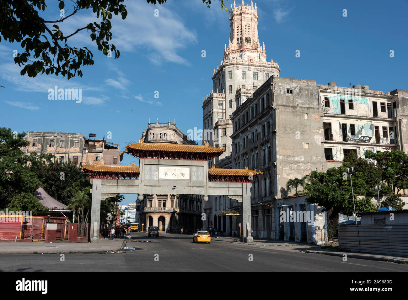 The Chinese Quarter Gate or the paifang at the entrance of Havana's Chinatown -Barrio Chino in Cuba.   The tower is the ETECSA - Telecommunications Co Stock Photo