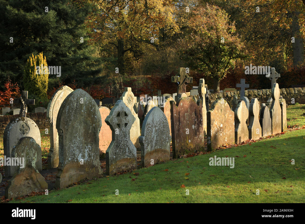 Gravestones lining a path in an English graveyard Stock Photo - Alamy
