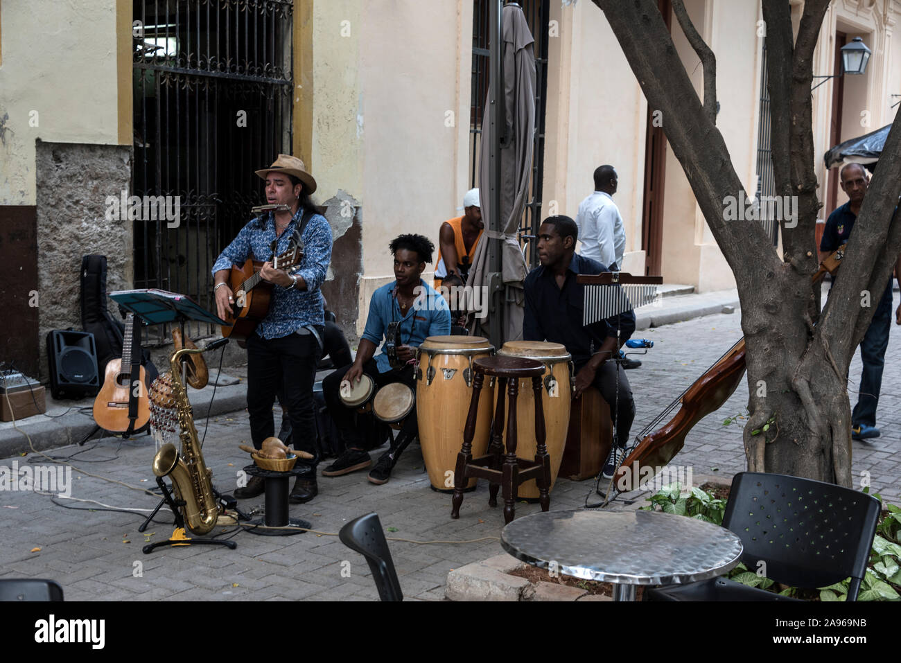 A Cuban music band  performing in front of a cafe audience in a side street of old Havana in Havana, Cuba Stock Photo