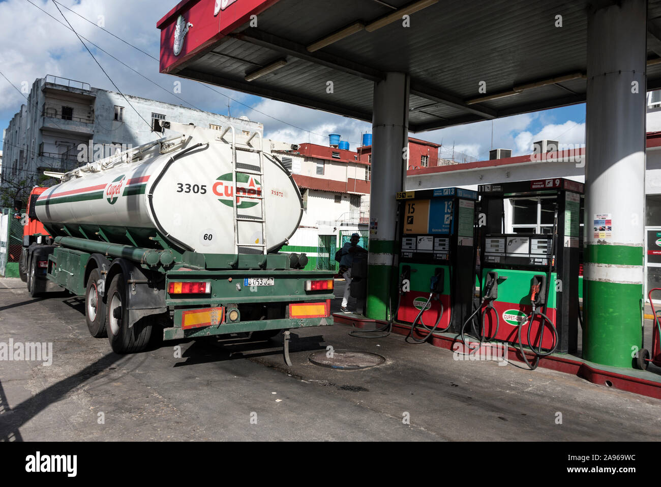 A petrol tanker delivering fuel to one of its garage outlets in Havana, Cuba.   The Cuba Oil Union ( Unión Cuba-Petróleo) -CUPET is Cuba's largest oil Stock Photo