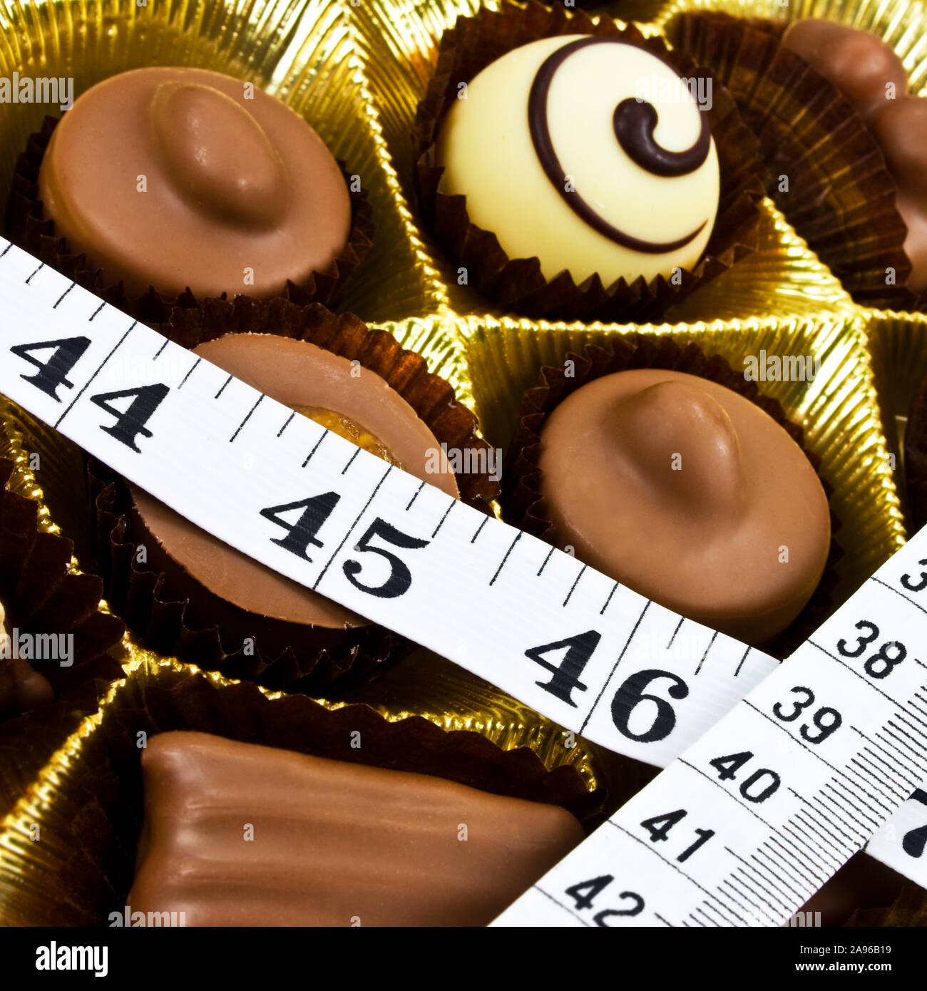 Chocolate and measuring tape close up Stock Photo - Alamy