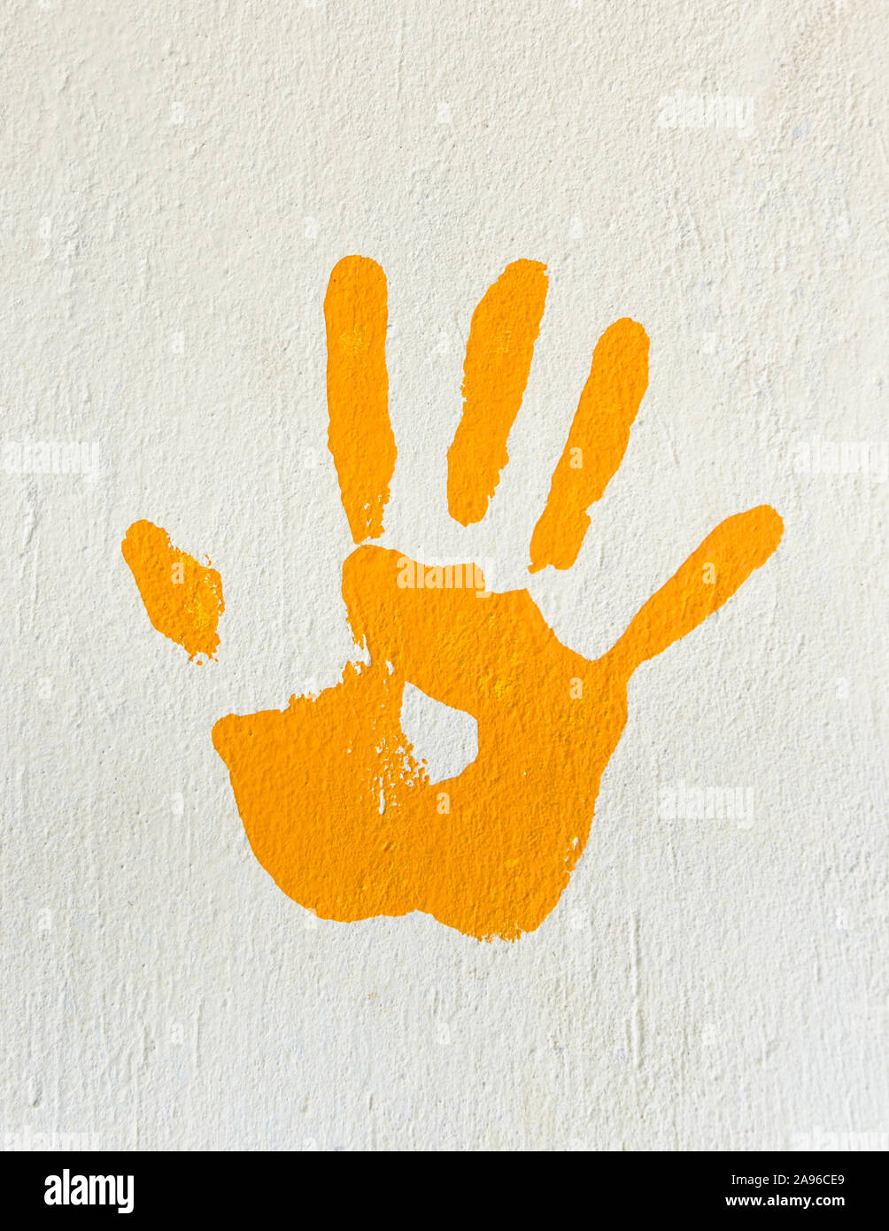 Orange handprint on a wall Stock Photo