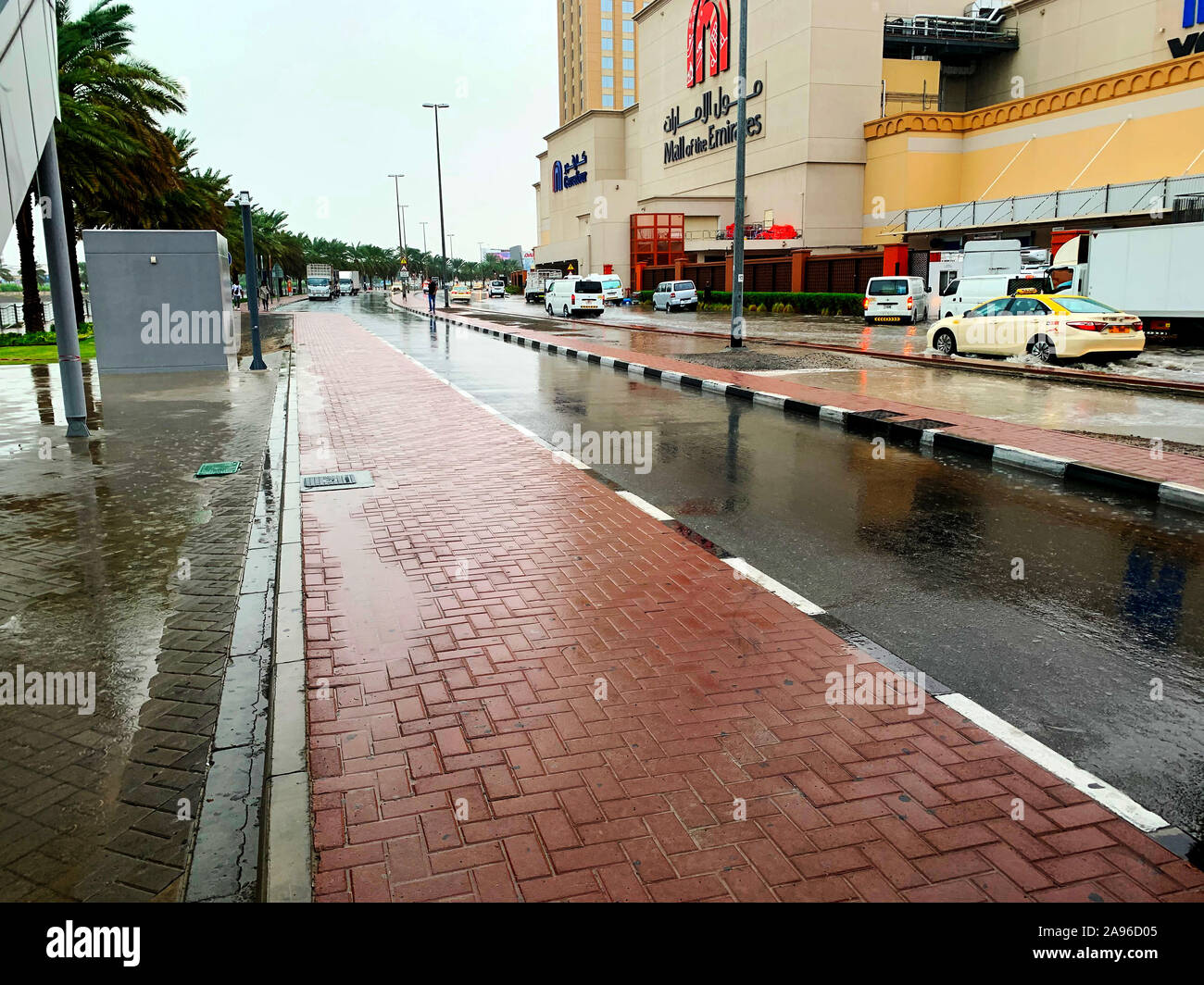 Dubai / UAE - November 10, 2019: Cars driving through the flooded streets in Dubai during rain. Heavy rain in UAE and puddles. Rainy in desert Stock Photo