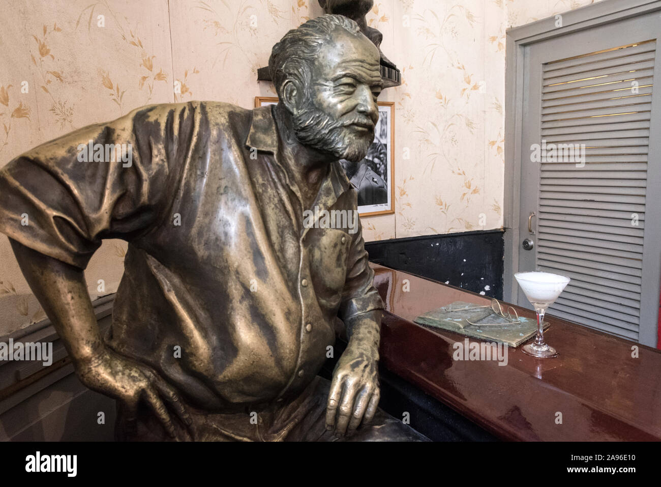 A life-like statue of American author, Ernest Hemingway standing at the El Floridita bar (one of his regular bar haunts) in Obispo in old Havana in Cu Stock Photo