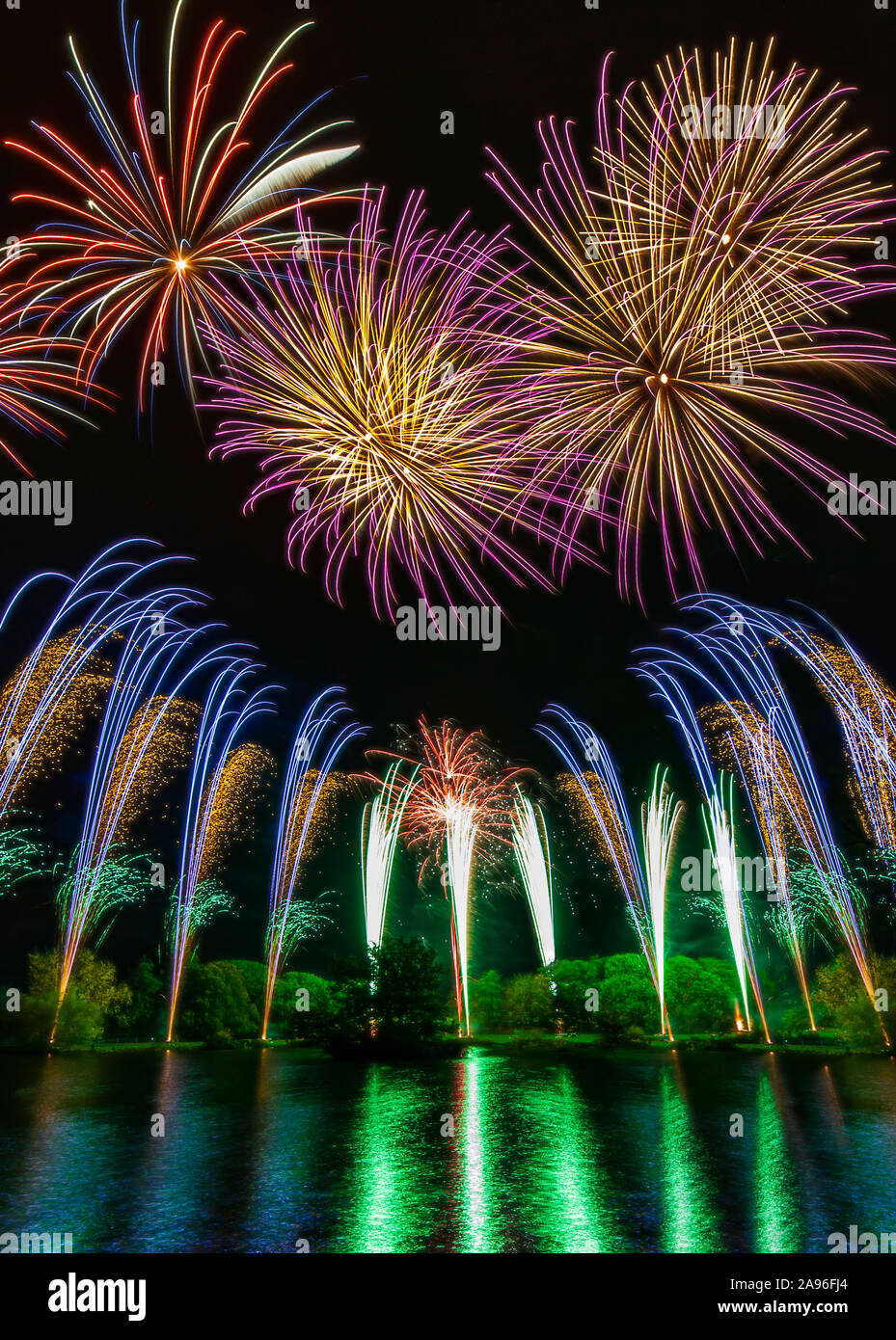 Firework display over water. Stock Photo