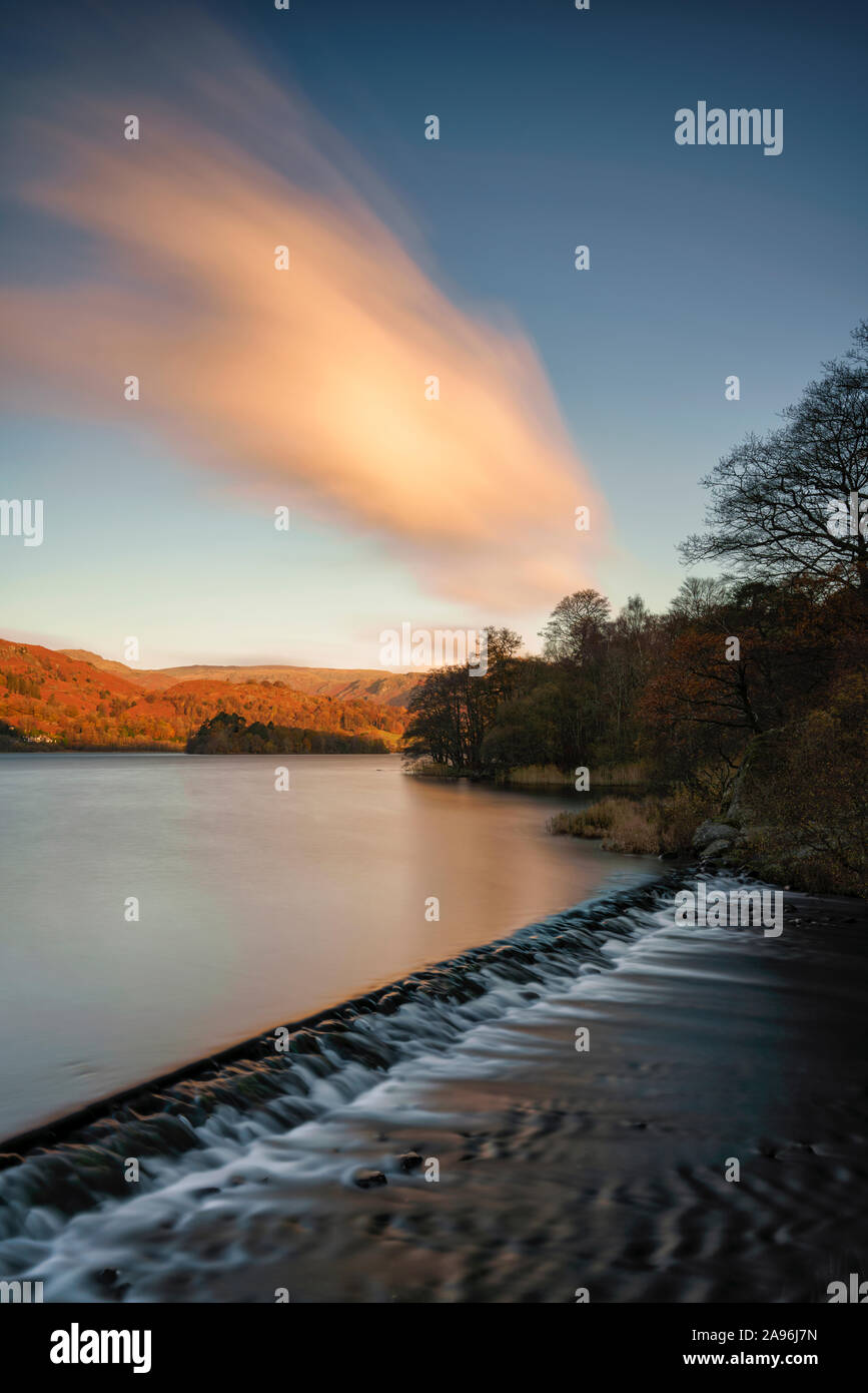 Long exposure image of the weir on Grasmere Lake at dawn in the English Lake District National Park Stock Photo
