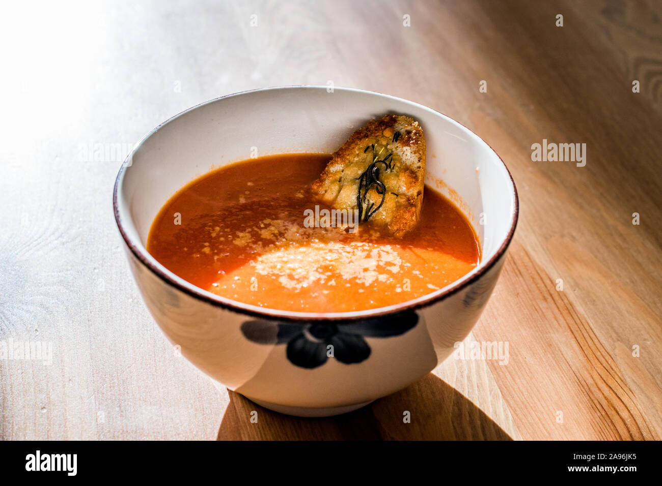 https://c8.alamy.com/comp/2A96JK5/tomato-soup-with-parmesan-cheese-bread-in-natural-light-and-sunlight-homemade-organic-food-2A96JK5.jpg
