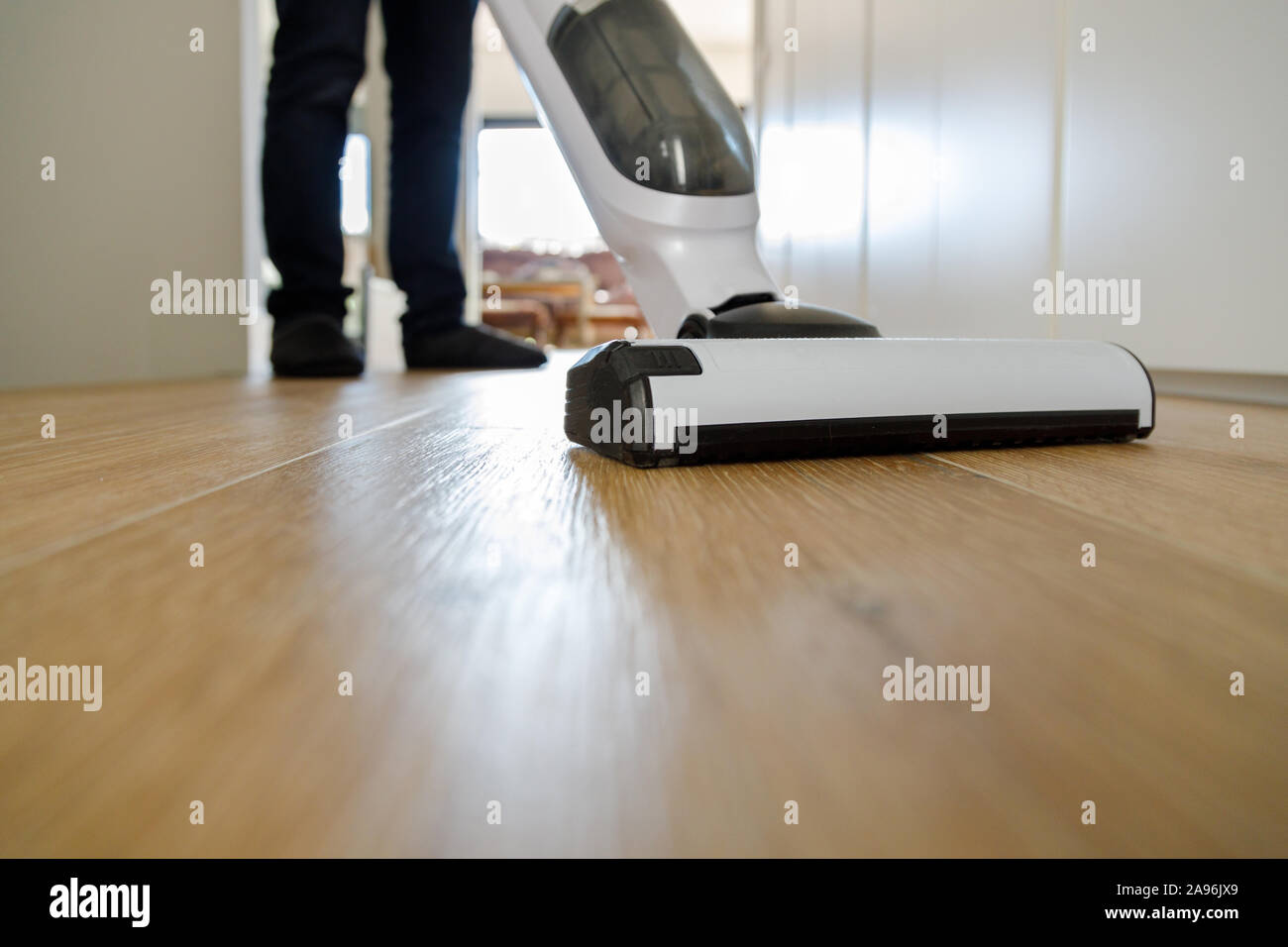 Man running the vacuum cleaner on the floor Stock Photo Alamy