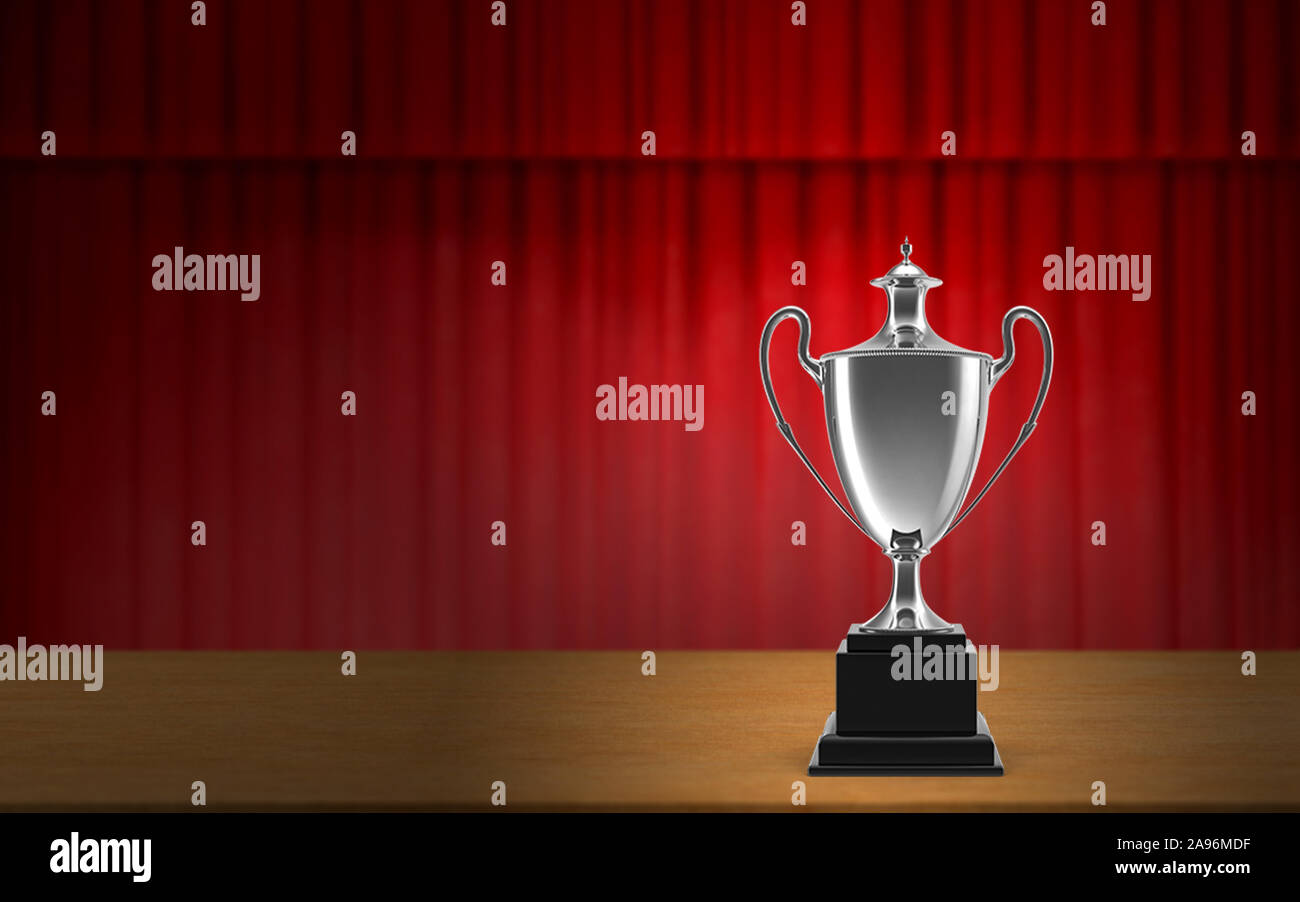Gold, Silver and Bronze trophy cups on stage In front of red curtain to