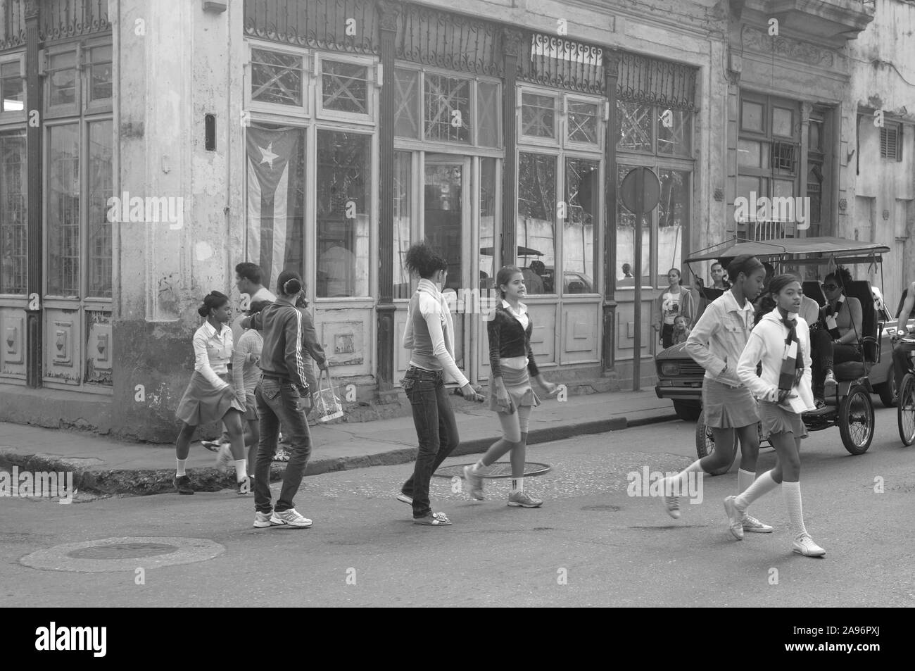 Cuba: schoolkids crossing a street in Havanna city Stock Photo