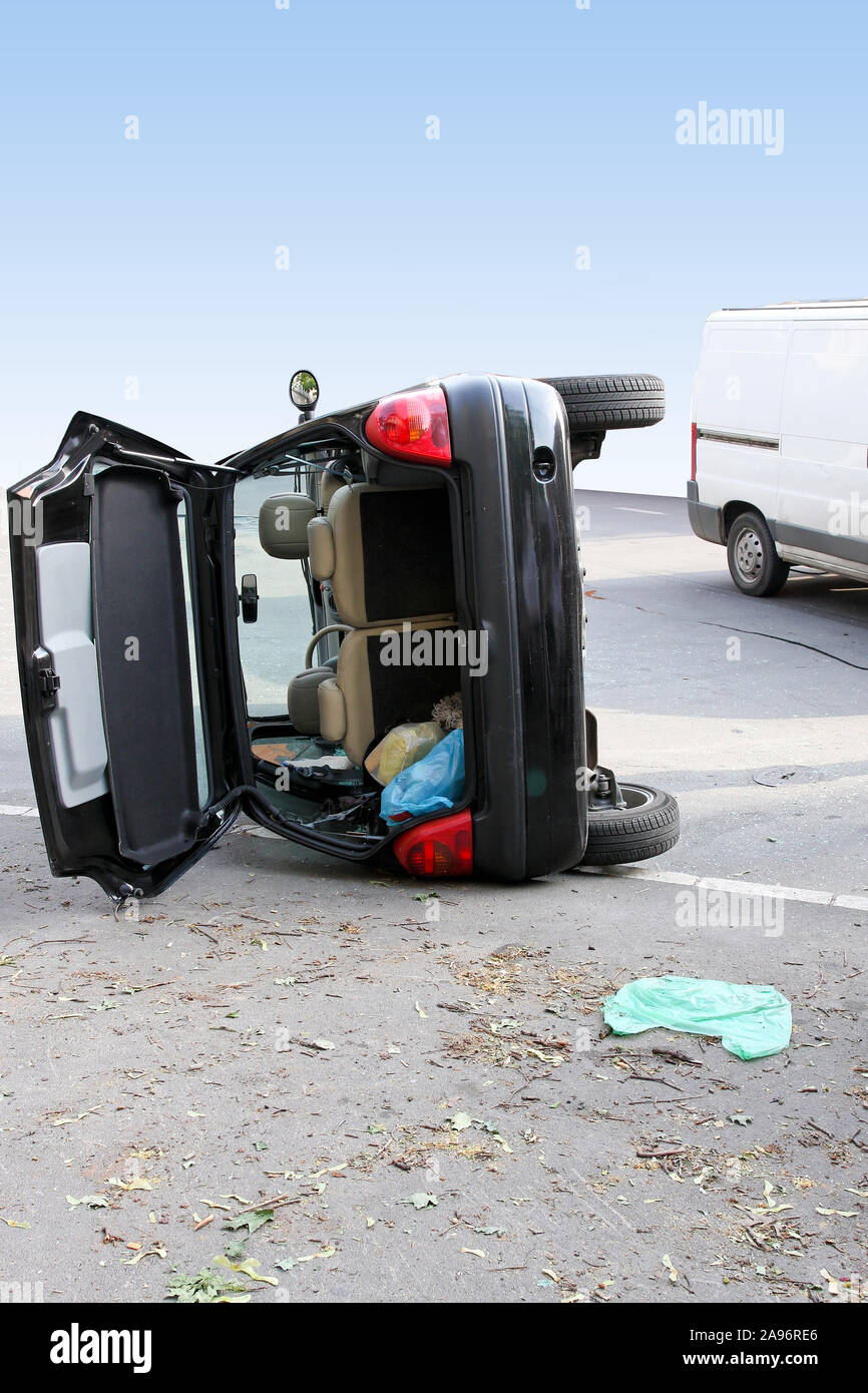 Traffic accident black car roll over side Stock Photo
