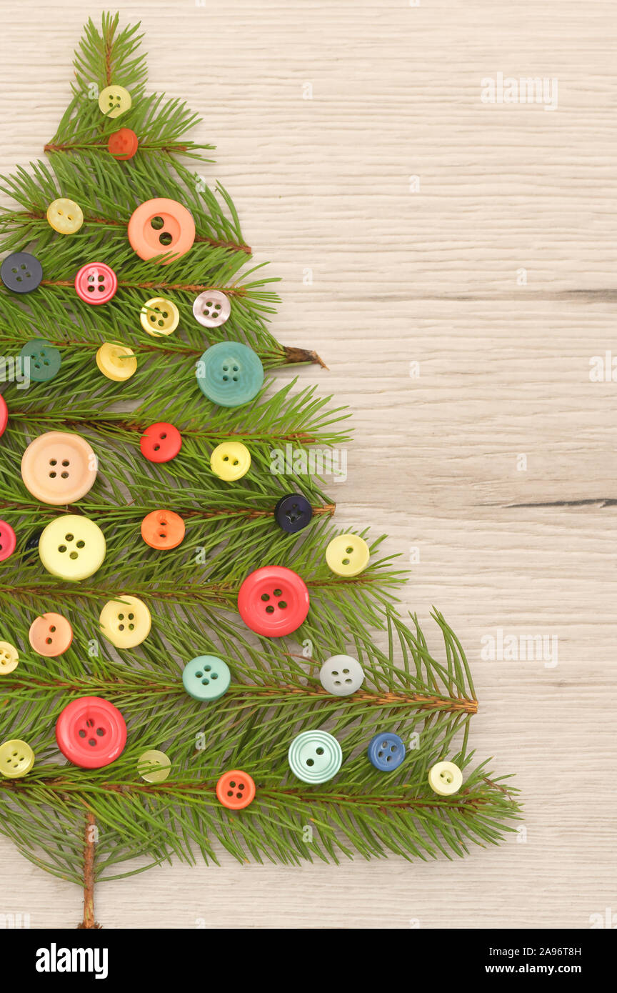 Pine Tree Buttons Christmas Tree Made With Pine Branches And Buttons on Wooden Table ...