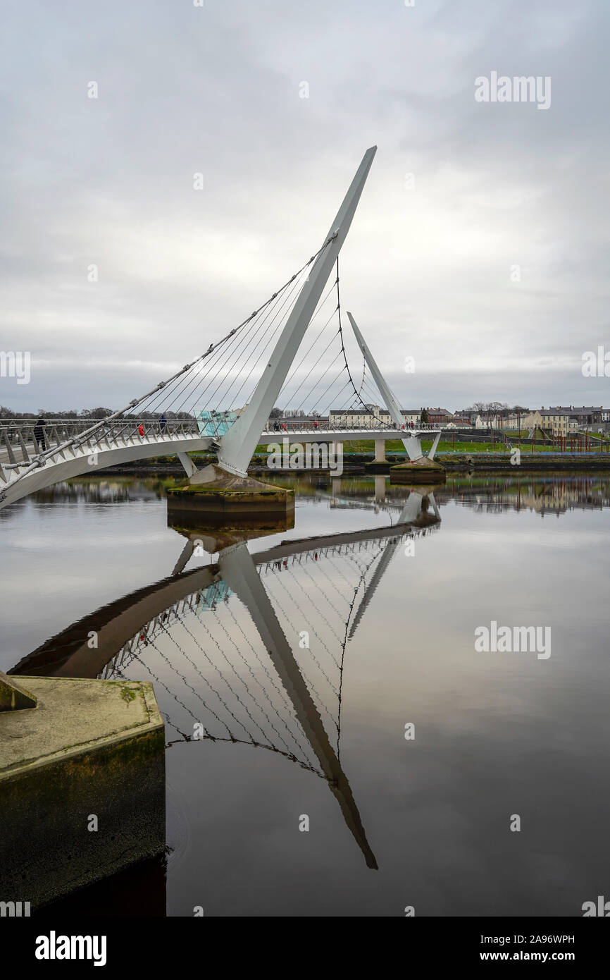 The Peace Bridge  a cycle and foot bridge across the River Foyle in Derry, Northern Ireland. Stock Photo