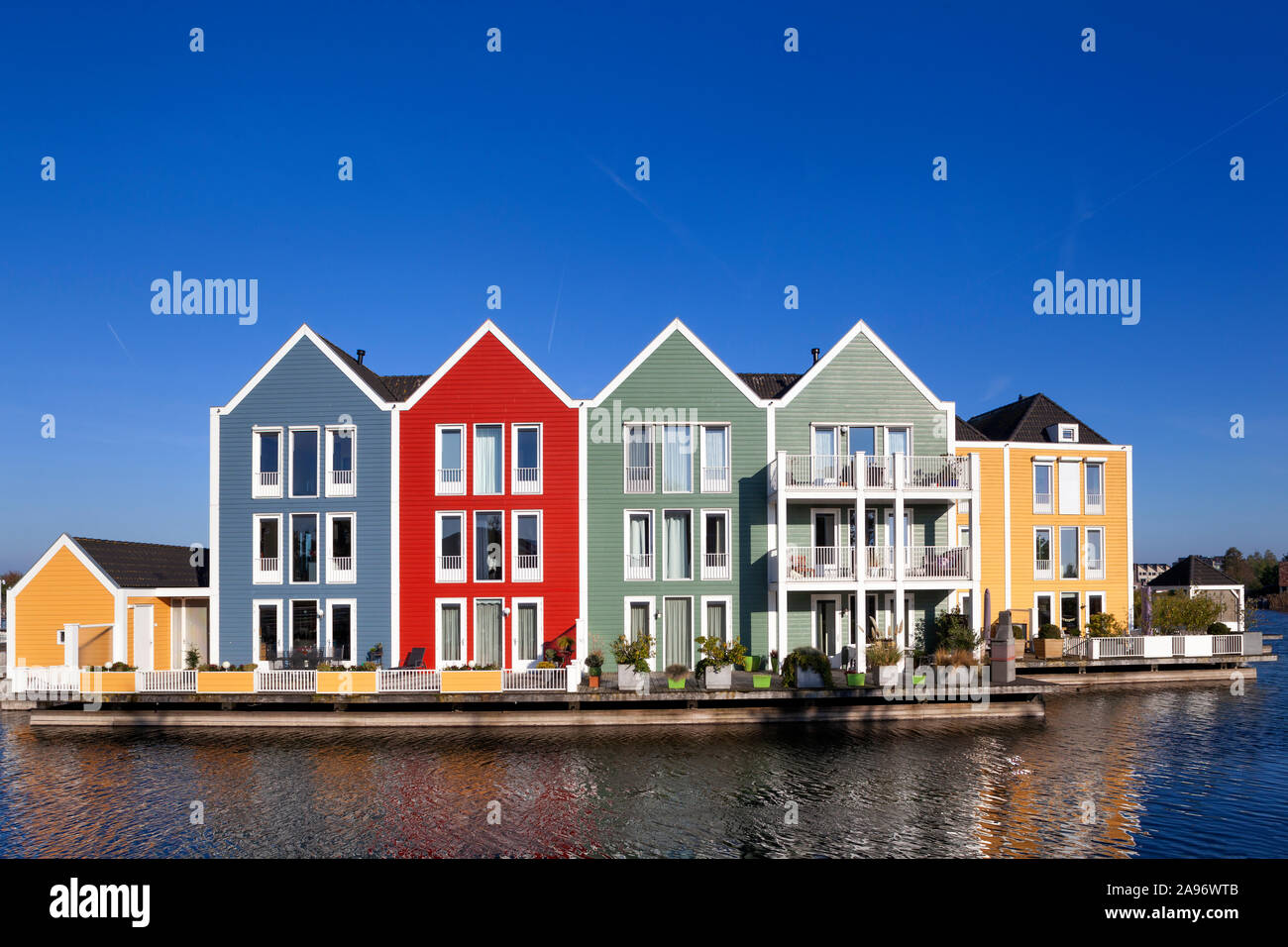 Colorful houses surrounded by water in Houten in the Netherlands Stock