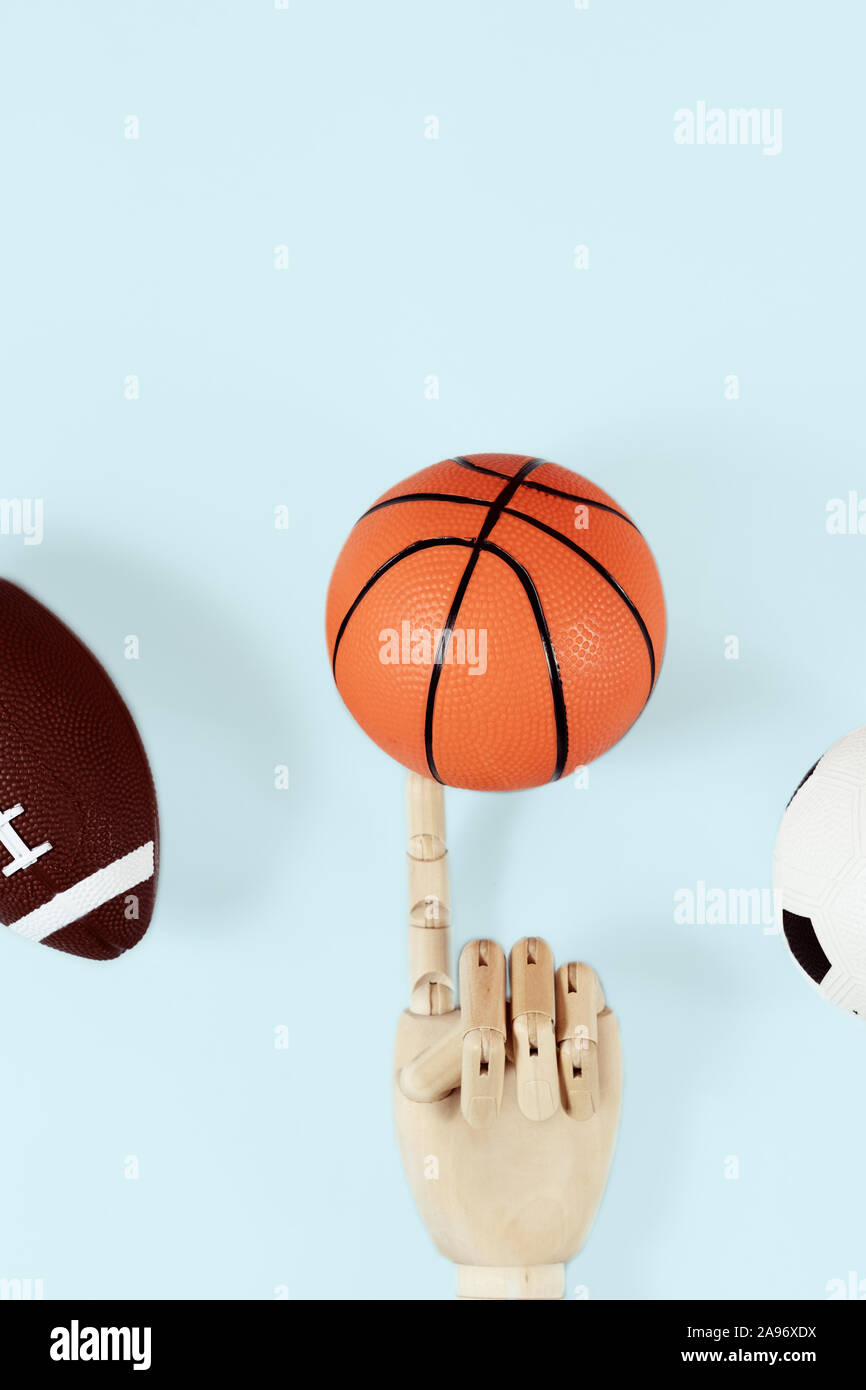 Flat lay of hand holding small basketball ball minimal creative concept. Stock Photo