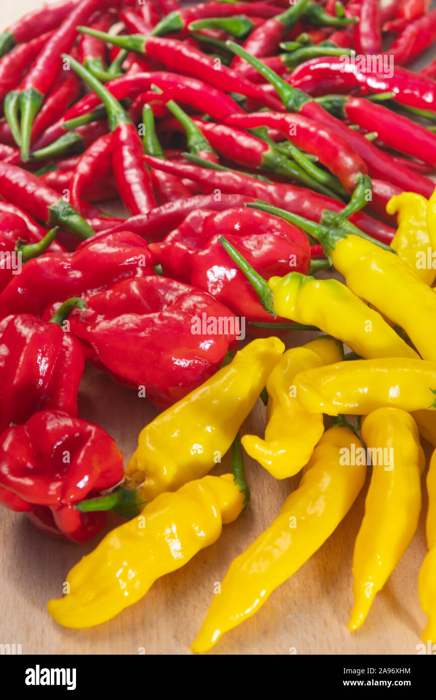 Closeup of lemon drop, habanero and thai peppers on light wooden surface, viewed from above Stock Photo