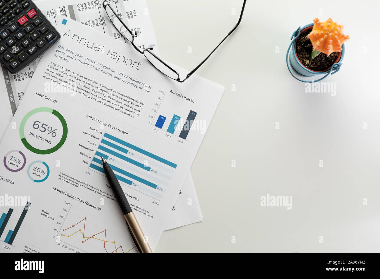 Download Mockup Annual Report Sheet With Charts And Graphs Pen Calculator Eyeglasses And Cactus On White Desk Accounting Business Finance Tax And Office Stock Photo Alamy