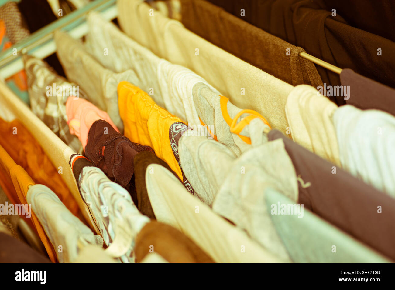 Colourful laundry drying on airer inside the house Stock Photo
