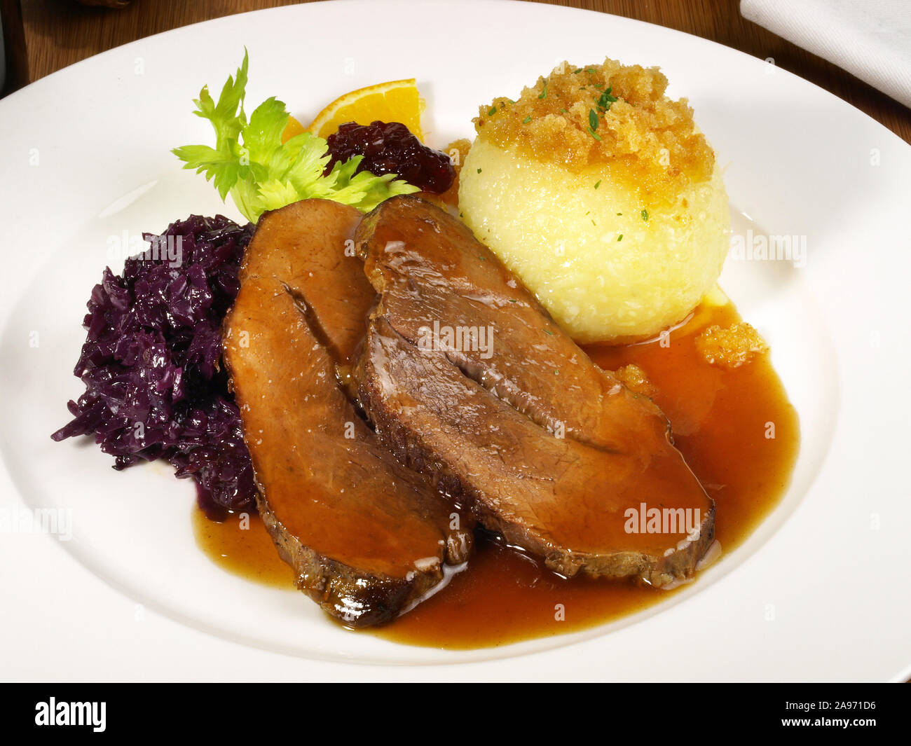 Wild Boar with Potato Dumpling and red Cabbage Stock Photo