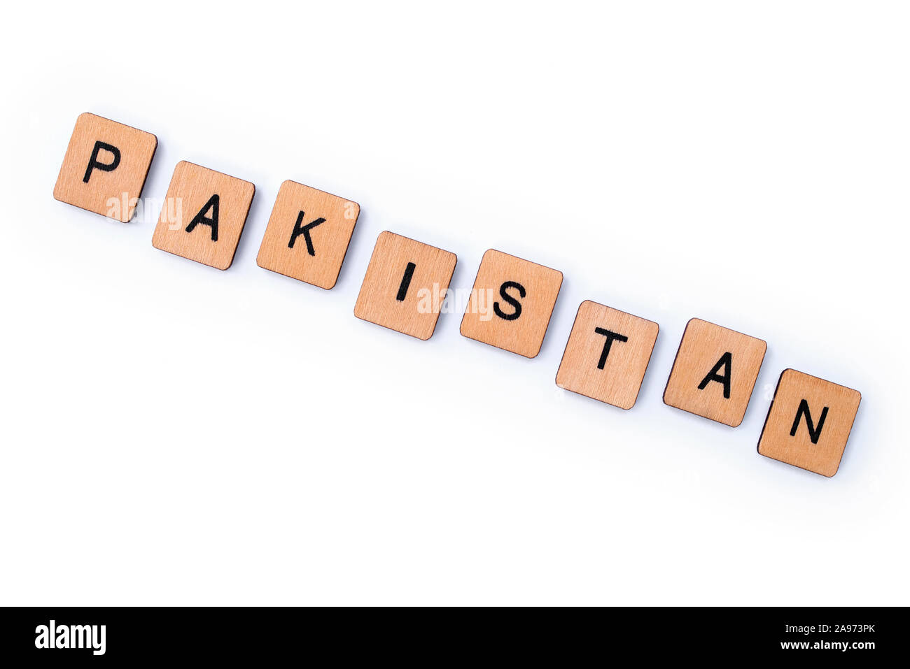 The word PAKISTAN, spelt with wooden letter tiles over a white background. Stock Photo