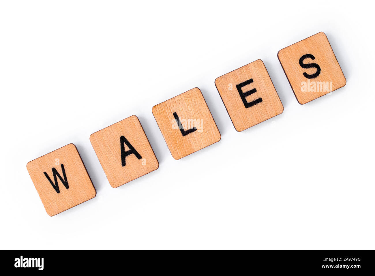 The word WALES, spelt with wooden letter tiles, over a plain white
