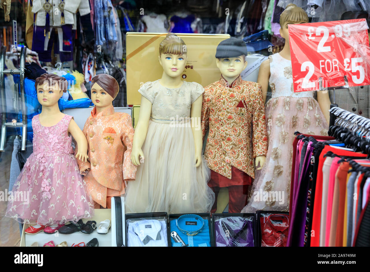 Punjabi, Indian and Asian children's clothes, traditional kids dresses and suit on mannequins in shop window display, Southall, London, UK Stock Photo