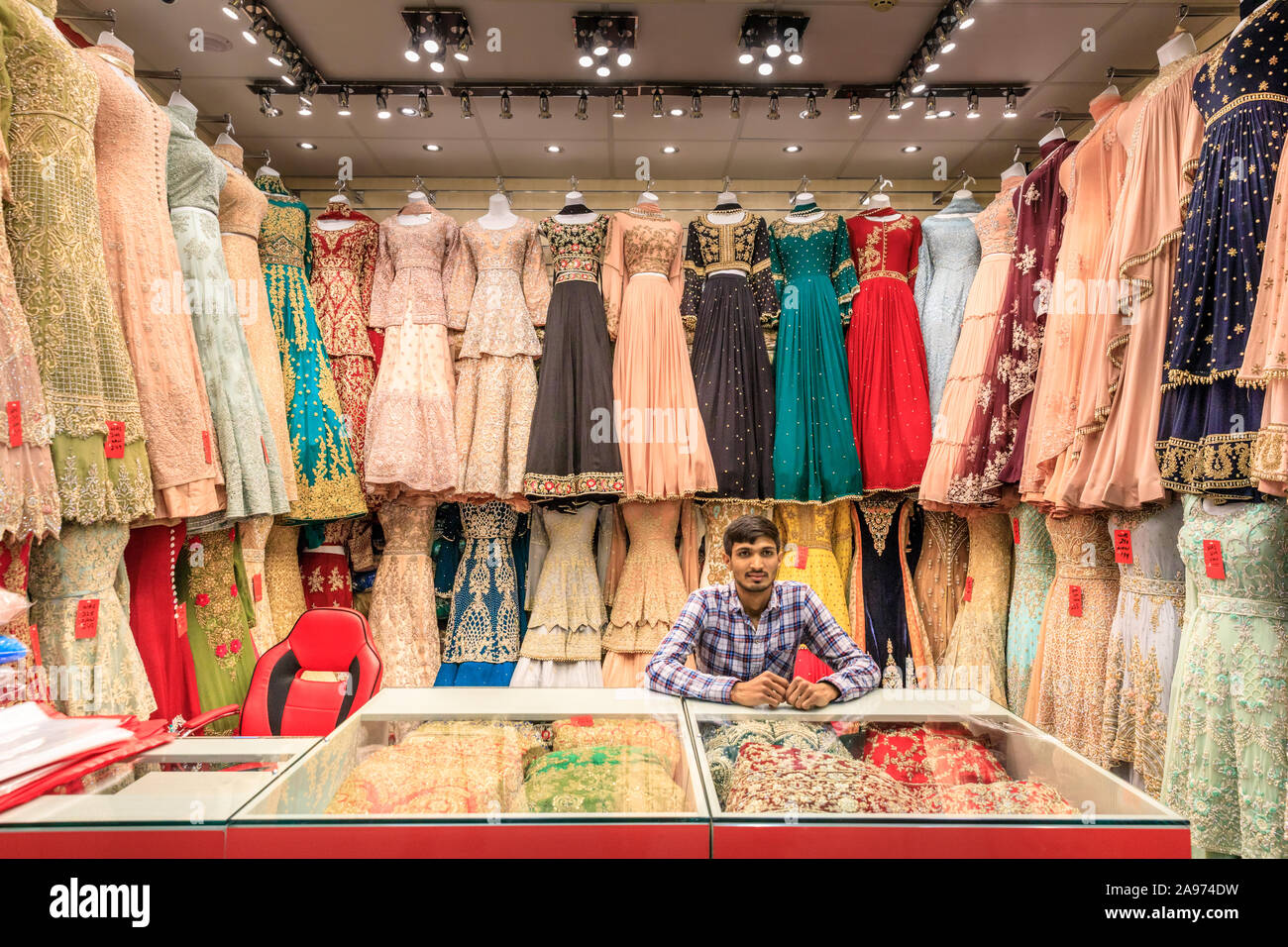 Punjabi, Indian and Asian dresses and saris on display, traditional, colourful evening wear and clothes in a shop in Southall, London, UK Stock Photo