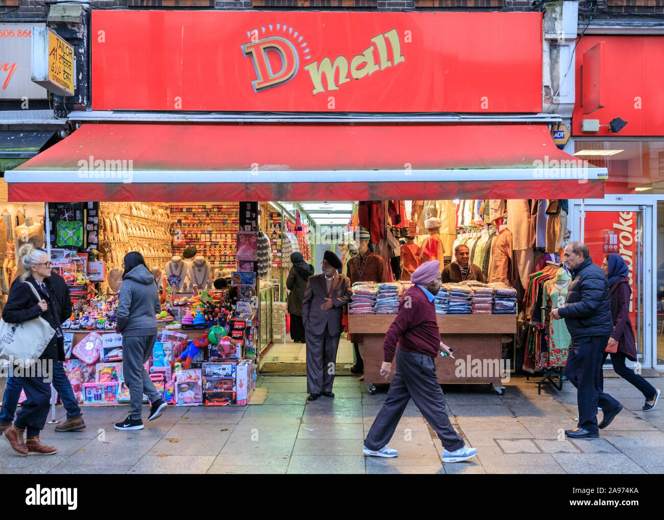 D Mall Asian clothing shops and fashion mall exterior view of people browsing and shopping, Southall High Street, London, UK Stock Photo