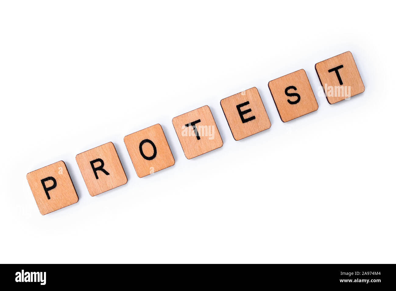 The word PROTEST, spelt with wooden letter tiles over a plain white background. Stock Photo