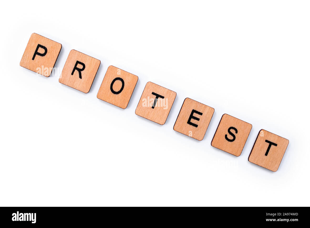 The word PROTEST, spelt with wooden letter tiles over a plain white background. Stock Photo