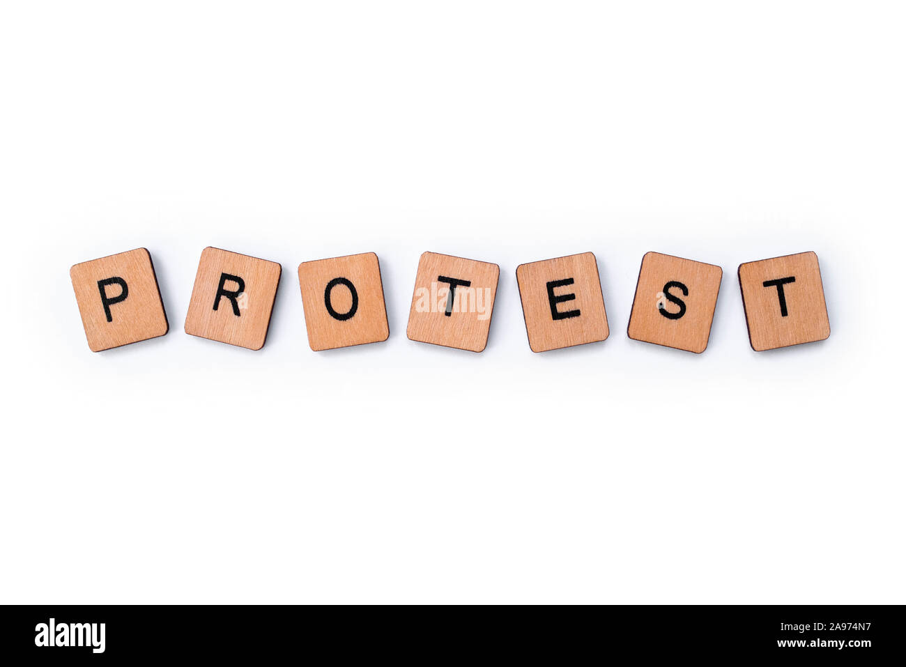 The word PROTEST, spelt with wooden letter tiles over a plain white background. Stock Photo